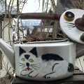 A kettle with a cat painted on it are Art made from Recycled Materials in Japan